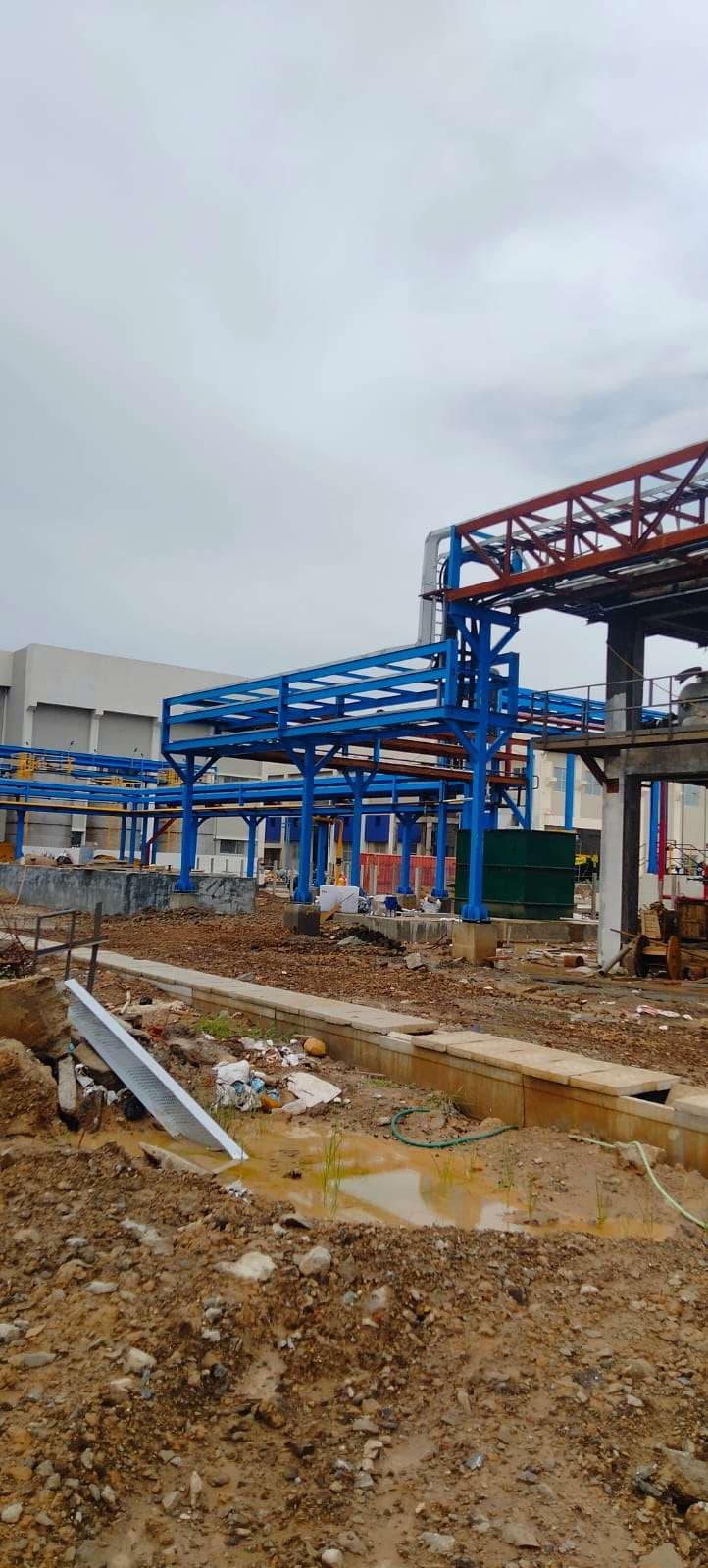 Blue-painted pipe rack steelwork erected at an industrial project site
